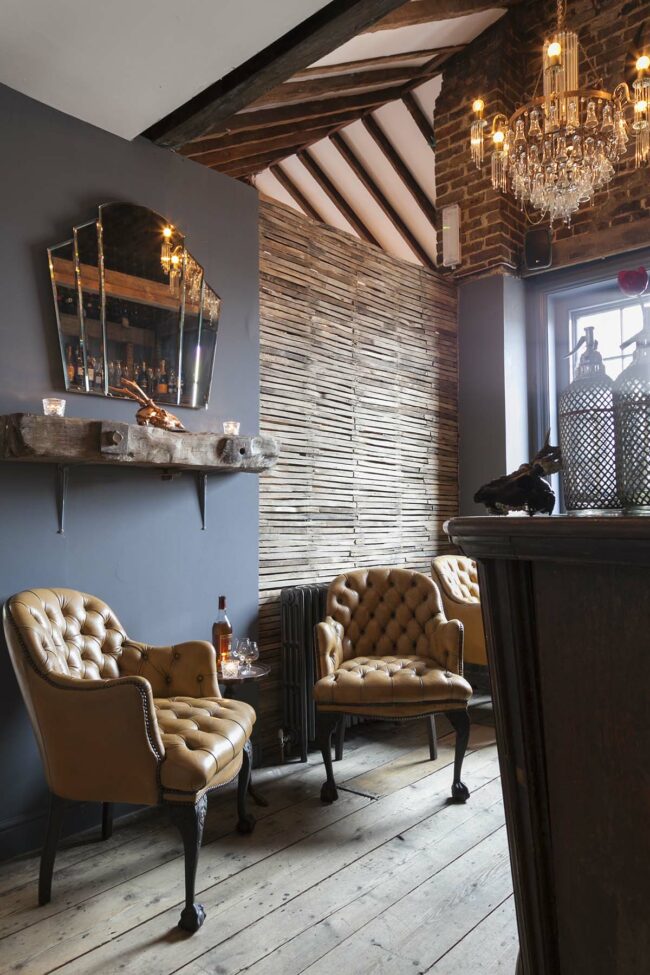 Attic dining room featuring several customized pieces from Emerald Faerie’s lighting collections.