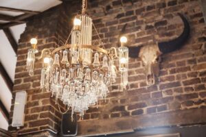 Attic bar featuring custom made Ambrosia chandelier made from liquor glasses.